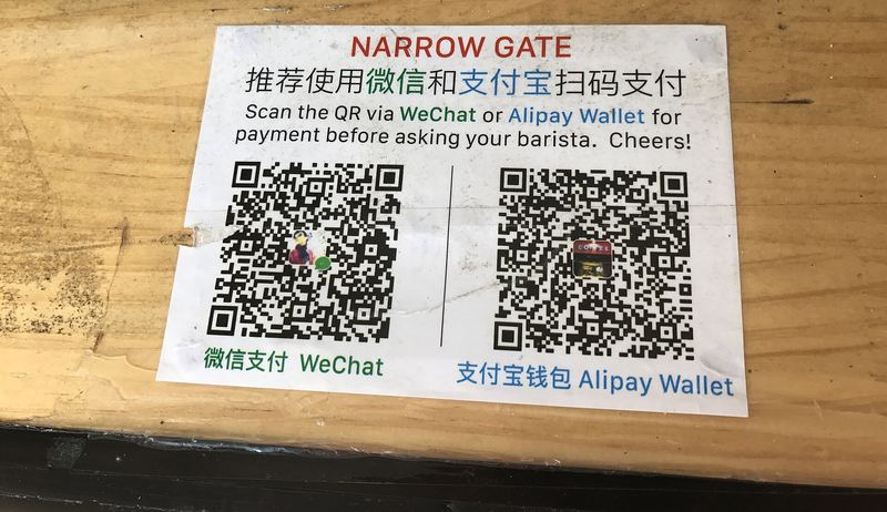 A QR code payment display at a shop counter in China