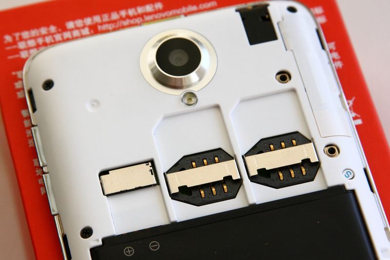 A SIM card being fitted into a mobile phone