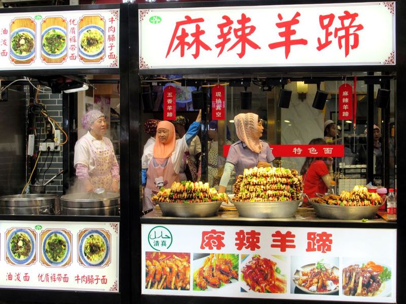 Lit food stalls and hanging lanterns in Xi’an’s Muslim Quarter at dusk